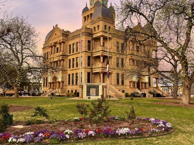 A vertical shot of the Denton County Courthouse in Texas, USA, featuring its impressive facade and columns